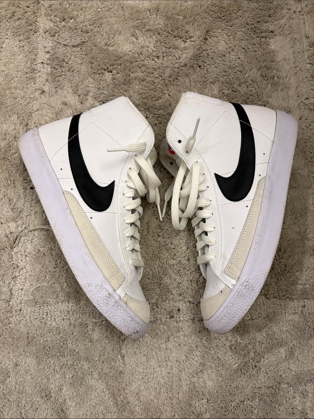 Nike White High-Top Sneakers with Black Swoosh